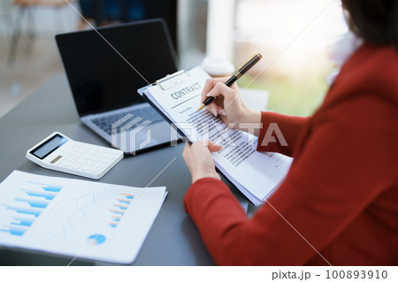 financial, Planning, Marketing and Accounting, portrait of Asian employee checking financial statements using documents and calculators at work.. 100893910