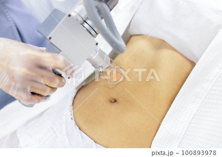Extreme close up of hand of doctor or cosmetologist in transparent glove, part of apparatus 100893978
