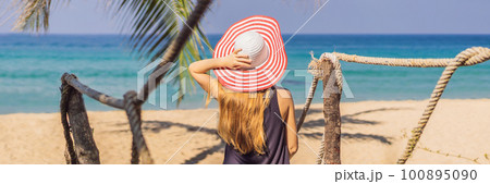 Vacation on tropical island. Woman in hat enjoying sea view from wooden bridge Vacation on tropical island. Woman in hat enjoying sea view from wooden bridge 100895090
