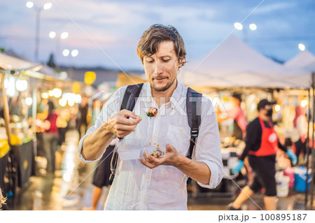 Young man tourist on Walking street Asian food market 100895187