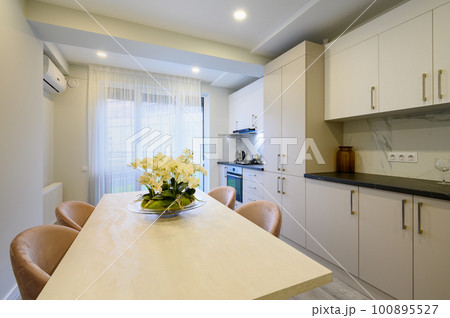 Large beige and cream luxury kitchen interior 100895527