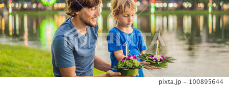 Father and son tourists celebrates Loy Krathong, Runs on the water. Loy Krathong festival, People buy flowers and candle to light and float on water to celebrate the Loy Krathong festival in Thailand 100895644