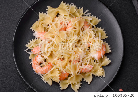 Delicious farfalle pasta with langoustine shrimp with creamy sauce Delicious farfalle pasta with langoustine shrimp with creamy sauce 100895720