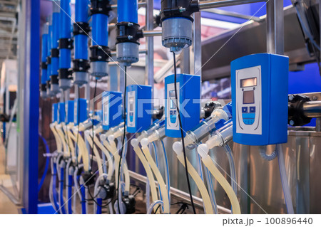 Automated goat milking suction machine with teat cups at exhibition Automated goat milking suction machine with teat cups at exhibition 100896440