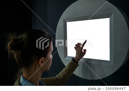 Woman touching white blank display of electronic kiosk - mockup image Woman touching white blank display of electronic kiosk - mockup image 100896447