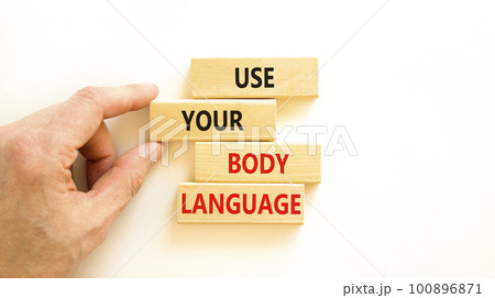Use your body language symbol. Concept words Use your body language on wooden block. Beautiful white table white background. Motivational business use your body language concept. Copy space. 100896871