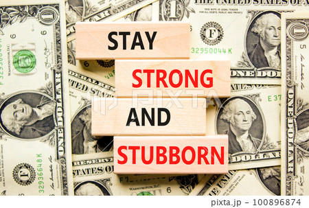 Stay strong and stubborn symbol. Concept words Stay strong and stubborn on wooden block. Beautiful background from dollar bills. Motivational business stay strong and stubborn concept. Copy space. Stay strong and stubborn symbol. Concept words Stay strong and stubborn on wooden block. Beautiful background from dollar bills. Motivational business stay strong and stubborn concept. Copy space. 100896874