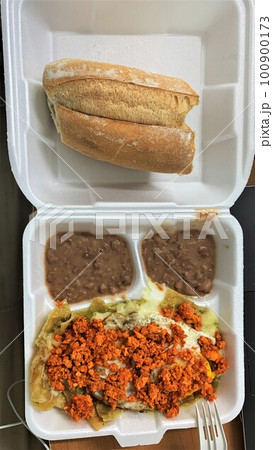 Mexican breakfast chilaquiles rojos con chorizo, huevo and bolillo Mexican breakfast chilaquiles rojos con chorizo, huevo and bolillo 100900173