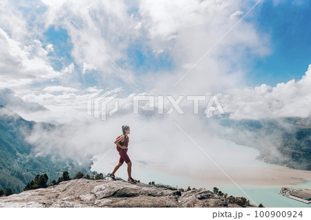 Hiking adventure in amazing nature landscape on Squamish Stawamus Chief Hike. Woman hiking on summit of First Peak, British Columbia, Canada. Popular mountain destination for outdoor activity, Canada 100900924