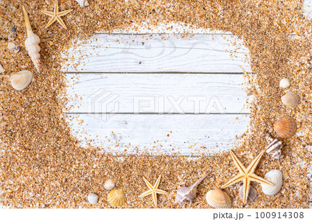 Sand seashells background. Summer time concept with sea shells and starfish on wooden background and sand Sand seashells background. Summer time concept with sea shells and starfish on wooden background and sand 100914308
