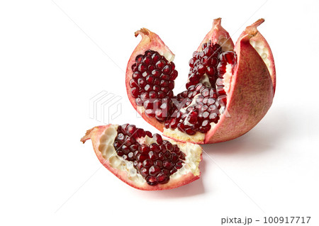 Beautifully cut broken ripe pomegranate isolated on white background Beautifully cut broken ripe pomegranate isolated on white background 100917717