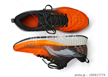 Orange running shoes isolated on white background. Shoes for walking, jogging, running, fitness, physical education Orange running shoes isolated on white background. Shoes for walking, jogging, running, fitness, physical education 100917774