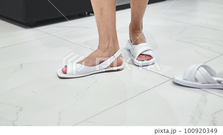 Girls trying on white summer sandals in the store. Girls trying on white summer sandals in the store. 100920349