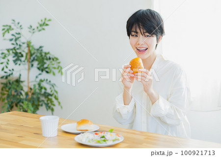 朝食を食べる若い女性　 100921713