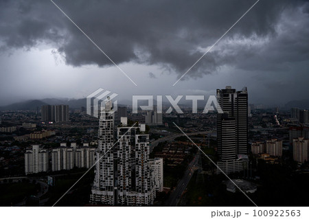 A black storm cloud of rain over the town. Bad weather conditions. 100922563