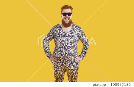 Portrait of funny comic fat man in leopard pajamas who laughs out loud on orange background. Portrait of funny comic fat man in leopard pajamas who laughs out loud on orange background. 100925180