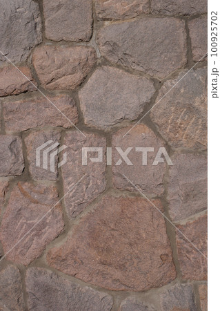 Pattern of ancient bricks and stones at old middle age wall, as a background, closeup, details. 100925702