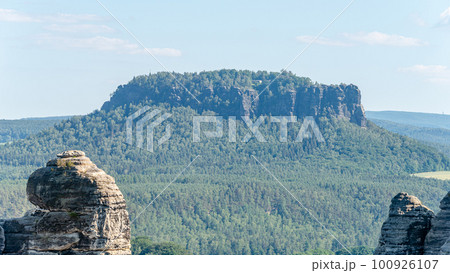 Panoramic view over monumental Lilienstein sandstone pillars, an iconic table like mount at sunset in the national park Saxon Switzerland by Dresden and Czechish border, Saxony, Germany. Panoramic view over monumental Lilienstein sandstone pillars, an iconic table like mount at sunset in the national park Saxon Switzerland by Dresden and Czechish border, Saxony, Germany. 100926107