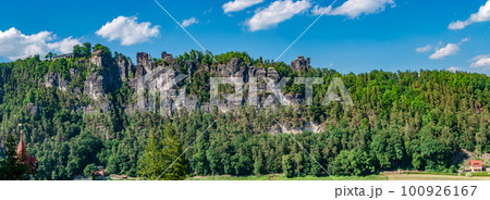 Panoramic view over monumental Bastei sandstone pillars and ancient bridge near Kurort Rathen village in the national park Saxon Switzerland by Dresden and Czechish border, Saxony, Germany. 100926167