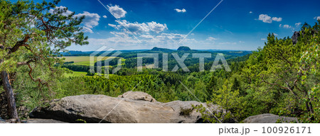 Panoramic view over monumental Bastei ancient sandstone pillars near Kurort Rathen village in the national park Saxon Switzerland by Dresden and Czechish border, Saxony, Germany. Panoramic view over monumental Bastei ancient sandstone pillars near Kurort Rathen village in the national park Saxon Switzerland by Dresden and Czechish border, Saxony, Germany. 100926171