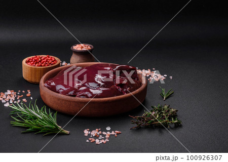 Fresh raw chicken, turkey or duck liver with salt, spices and herbs Fresh raw chicken, turkey or duck liver with salt, spices and herbs 100926307