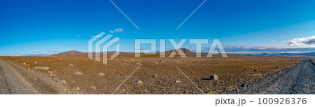 Panoramic over Icelandic Moon Lunar landscape near colorful volcanic caldera Askja, in the middle of volcanic desert in Highlands, blue sky, Iceland, lonely dirt road 100926376
