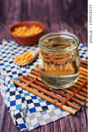 close up of Raw soy bean seed oil in a container close up of Raw soy bean seed oil in a container 100928335