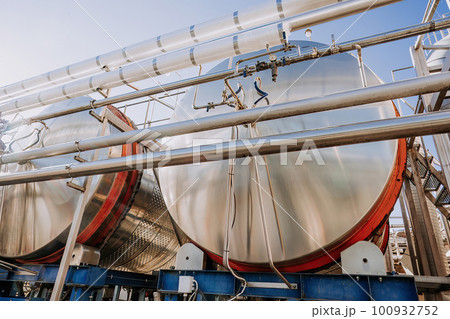 Steel modern cisterns for wine production on plant territory. Large tanks Steel modern cisterns for wine production on plant territory. Large tanks 100932752