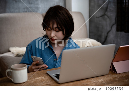 ノートパソコンを使うZ世代の若い女性 ノートパソコンを使うZ世代の若い女性 100935344