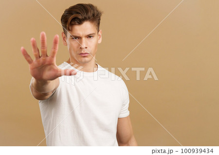 Handsome man gesturing stop with the palm of the hand 100939434
