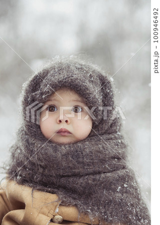 Retro photo of adorable baby in a woolen shawl in winter Retro photo of adorable baby in a woolen shawl in winter 100946492