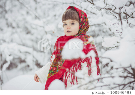 Beautiful little girl in old Ukrainian clothes in a winter forest Beautiful little girl in old Ukrainian clothes in a winter forest 100946493