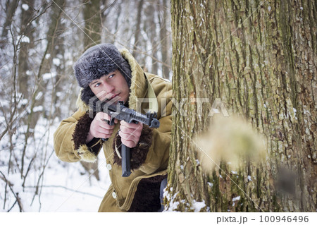 Soviet soldier in the winter forest. Retro photo 100946496