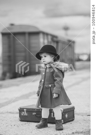 Retro photo of a baby girl who is waiting for a train 100946814