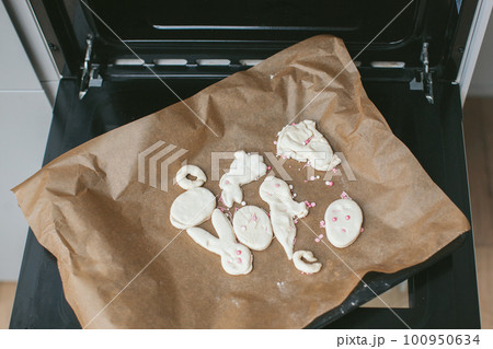 Homemade cookies in the shape of rabbit and eggs in oven. Homemade cookies in the shape of rabbit and eggs in oven. 100950634