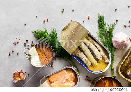 Open tin cans with canned fish 100950641