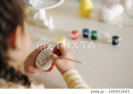 First person view of little girl painting easter egg First person view of little girl painting easter egg 100952695