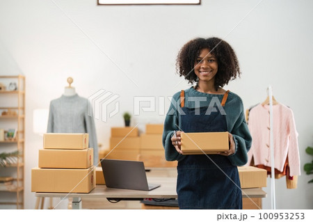 Young attractive woman owner startup business work happy with box at home prepare parcel delivery in sme supply chain, online delivery idea concept 100953253