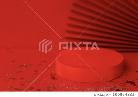 Empty holiday template for design with red round stage. Bright background with sparkles and confetti. Red paper fan on backdrope. Empty holiday template for design with red round stage. Bright background with sparkles and confetti. Red paper fan on backdrope. 100954832