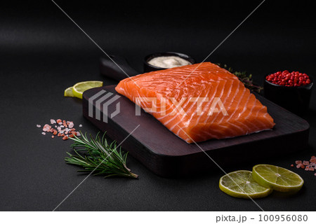 Fresh tasty raw red fish fillet with spices and herbs 100956080
