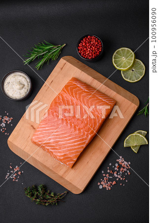 Fresh tasty raw red fish fillet with spices and herbs 100956090
