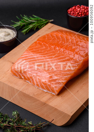Fresh tasty raw red fish fillet with spices and herbs 100956092