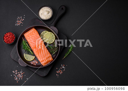 Fresh tasty raw red fish fillet with spices and herbs Fresh tasty raw red fish fillet with spices and herbs 100956098