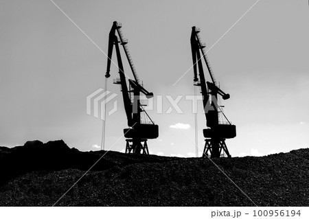 Coal mining. Cranes, coal industry, coal mines. Black and white photo 100956194