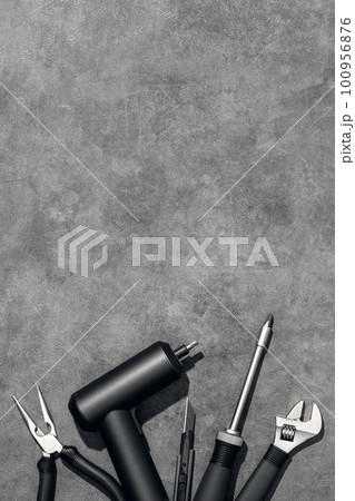 Flat lay composition with set of home repair tools on grey stone background. Top view pattern with copy space. 100956876