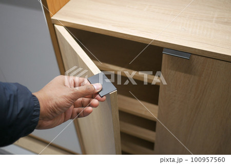 man's hand open drawer wooden in cabinet man's hand open drawer wooden in cabinet 100957560