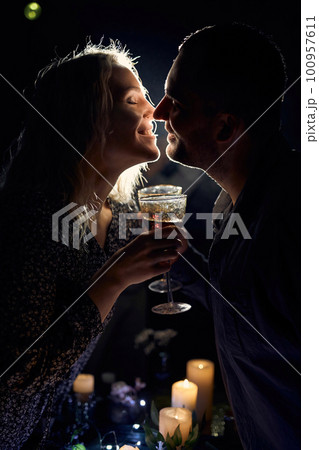 Romantic Couple with Wine Glasses and Candles 100957611