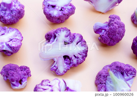 Purple cauliflower on old rose color background. 100960026