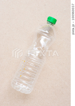 Plastic bottle on brown background. 100960037