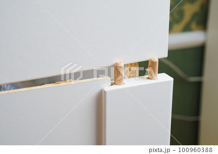 Broken white retractable box of cabinet. furniture repair 100960388